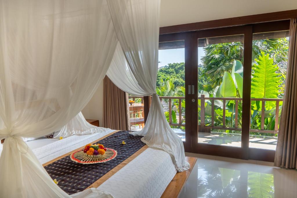 Postel nebo postele na pokoji v ubytování Mahadana Ubud
