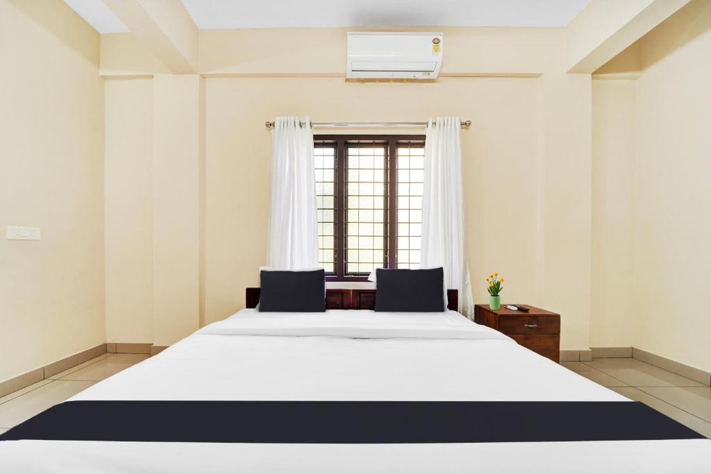 Postel nebo postele na pokoji v ubytování Super Hotel O Ambalamedu