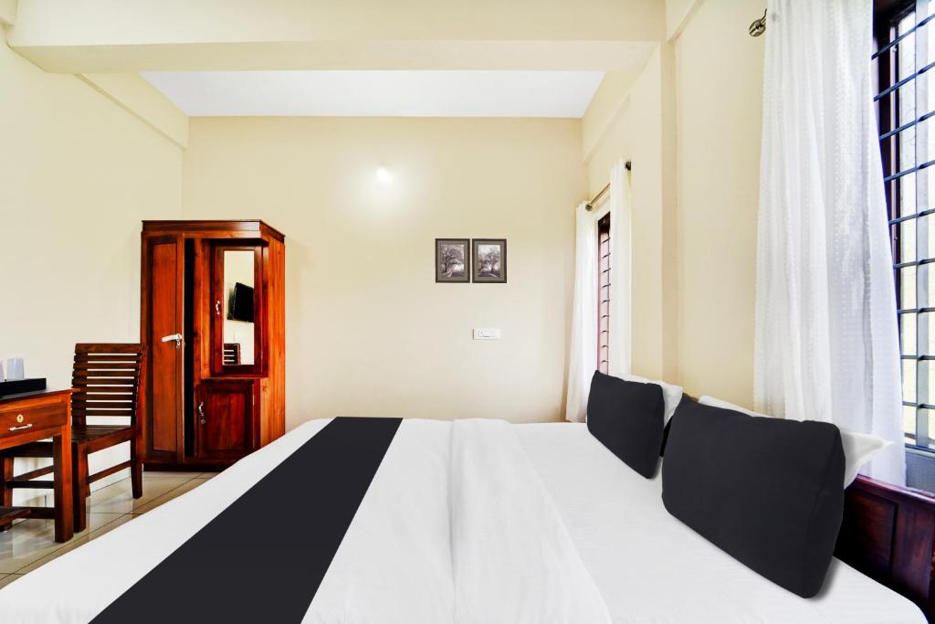 Postel nebo postele na pokoji v ubytování Super Hotel O Ambalamedu