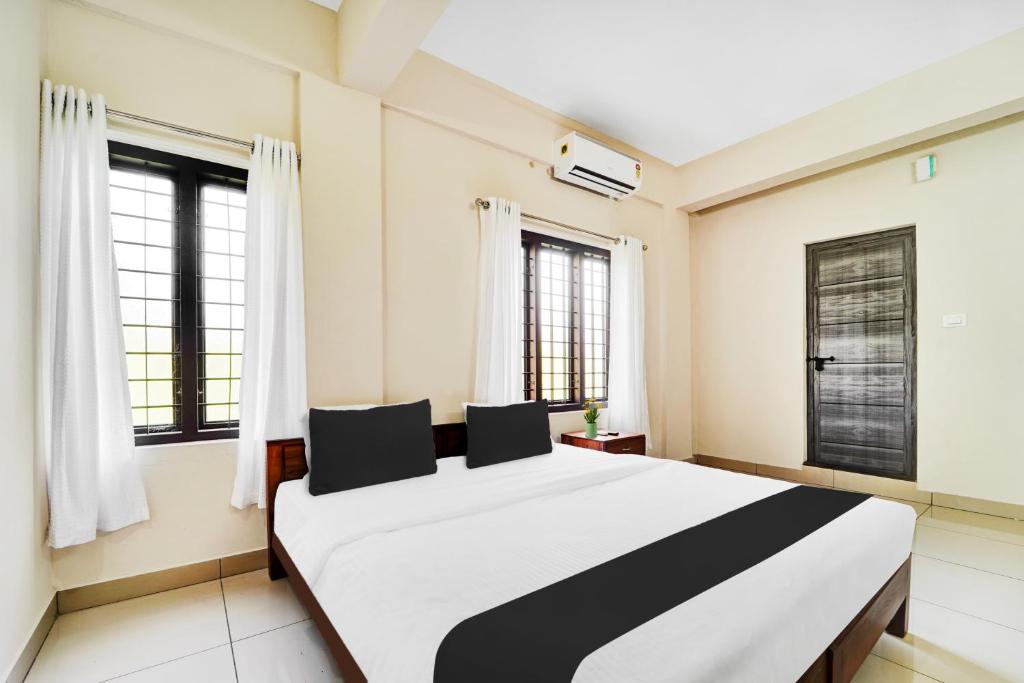 Postel nebo postele na pokoji v ubytování Super Hotel O Ambalamedu