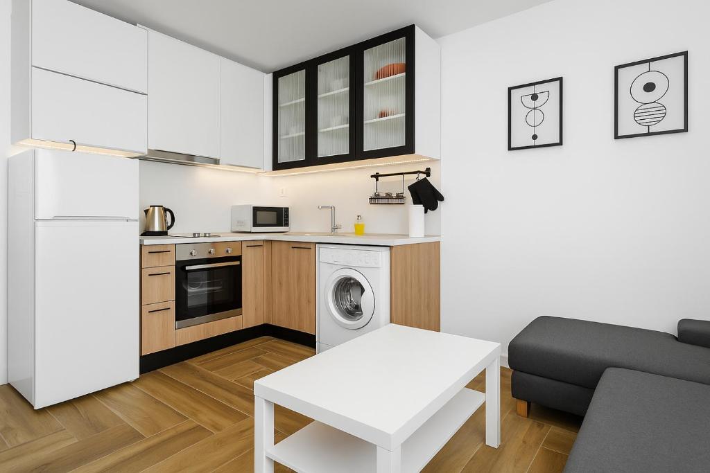 a small kitchen with a washer and dryer at North Panoramic Apartment in the art district of Kapana in Plovdiv