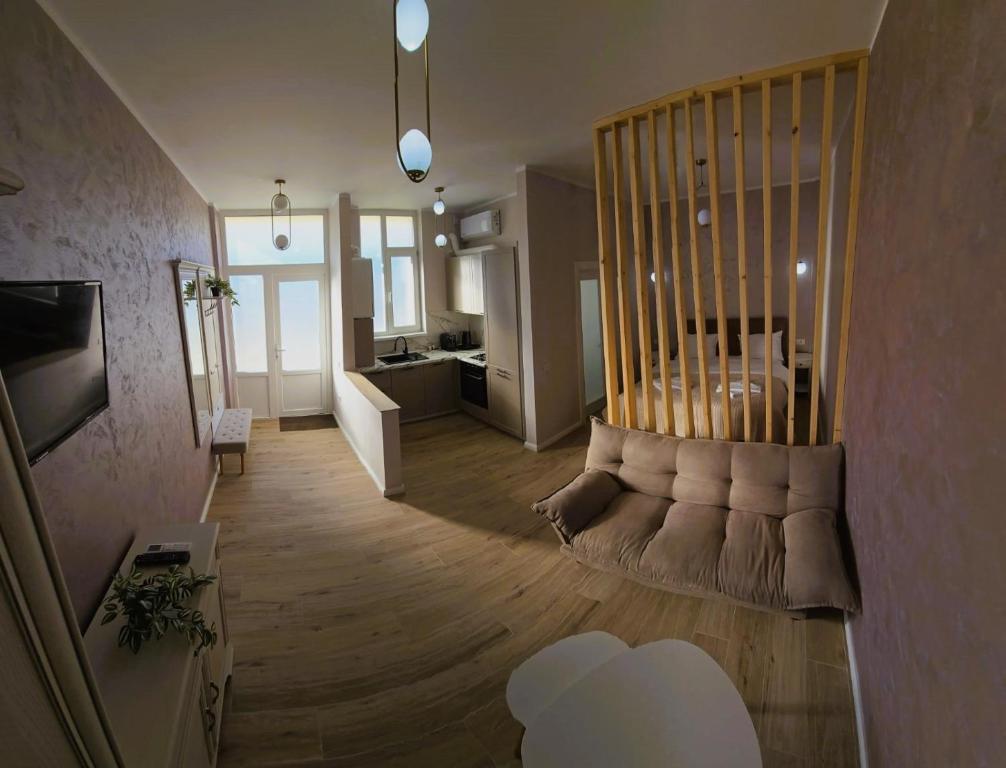 a living room with a couch in the middle of a room at N&D Arinis Studio in Gura Humorului