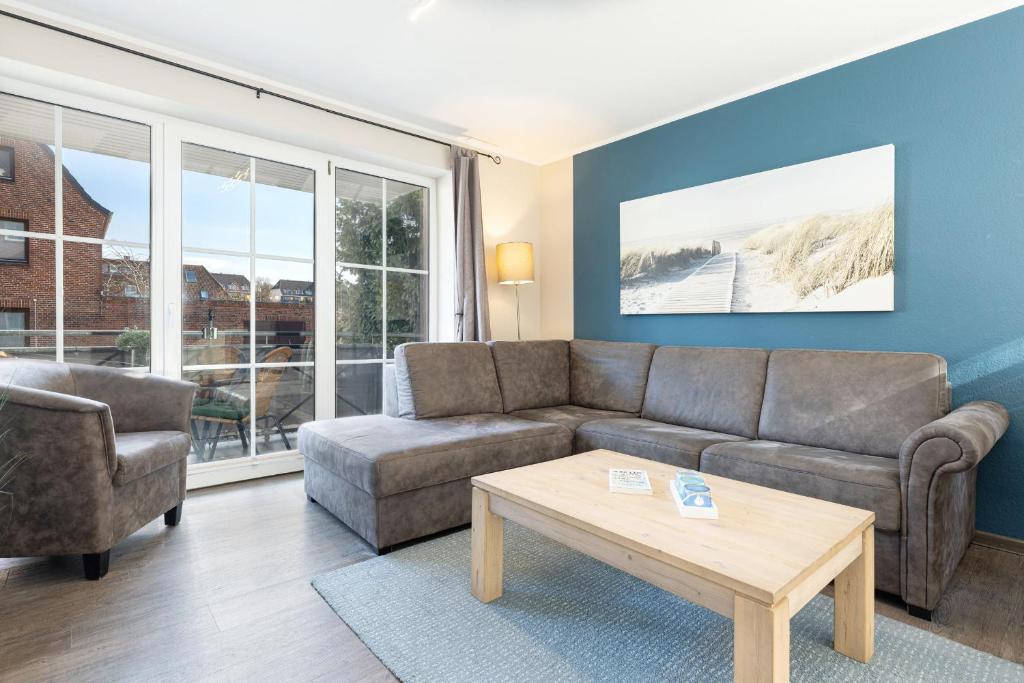 a living room with a couch and a coffee table at Bellevue 02 in Laboe