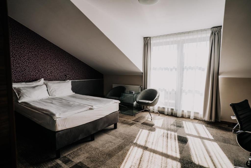 Posteľ alebo postele v izbe v ubytovaní Q Hotel Grand Cru Gdańsk