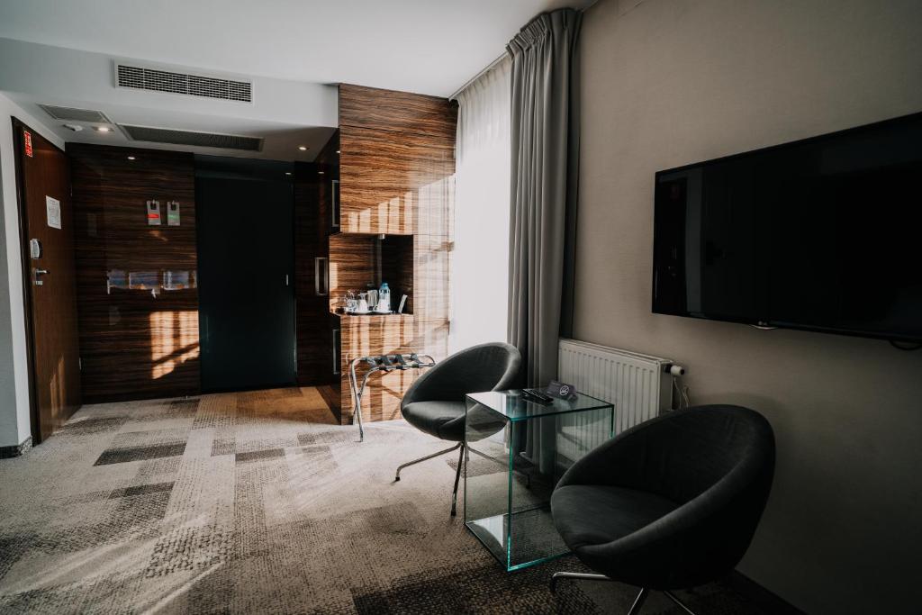 Televízia a/alebo spoločenská miestnosť v ubytovaní Q Hotel Grand Cru Gdańsk