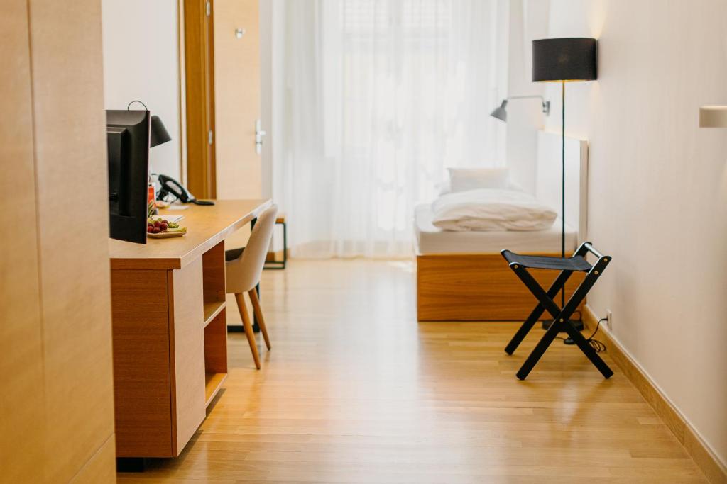 Postel nebo postele na pokoji v ubytování Hotel Benedict