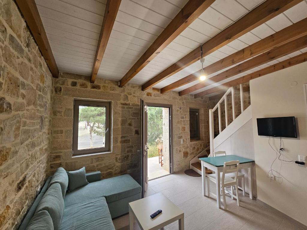 a living room with a couch and a table at Gem apartment Analipsi in Hersonissos