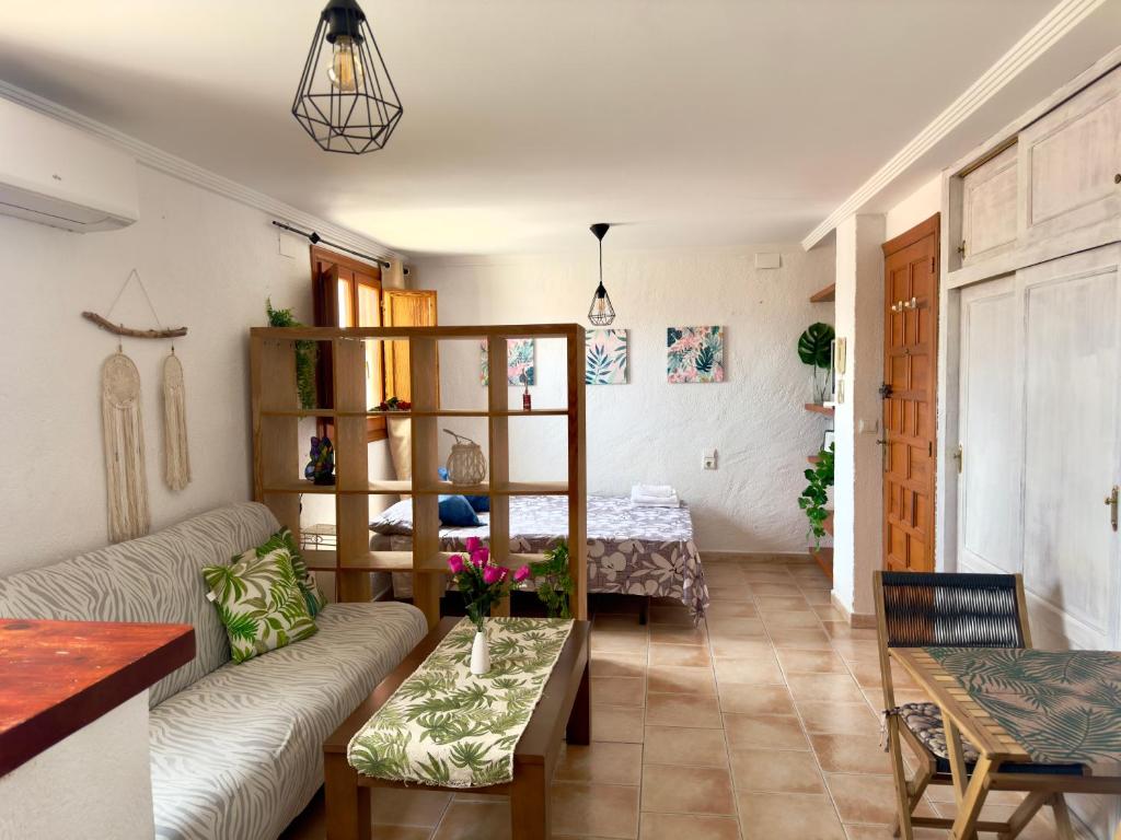a living room with a couch and a table at Estudio en el Castillo de Denia in Denia