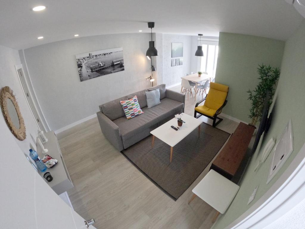 an overhead view of a living room with a couch and a table at Apartamentos La Encarnación V-VI cerca del mar in Los Alcázares