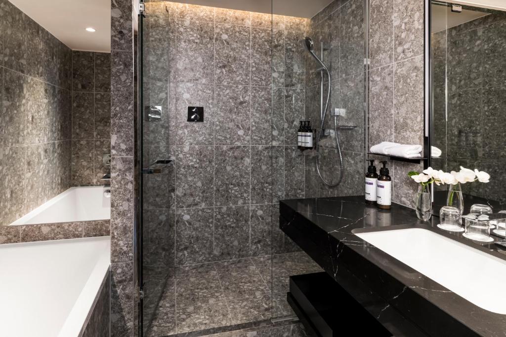 a bathroom with a shower and a sink and a tub at Hyatt Regency Tokyo in Tokyo