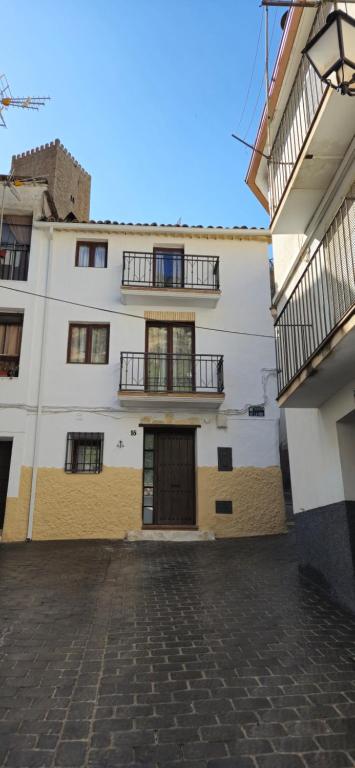 a large white building with two balconies on it at mirador de la sierra in Cazorla