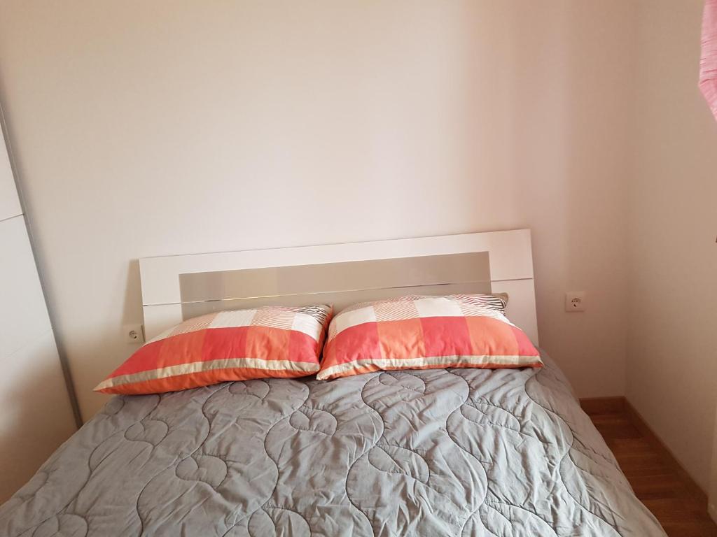 a bedroom with a bed with two pillows on it at Apartments Tereza in Senj