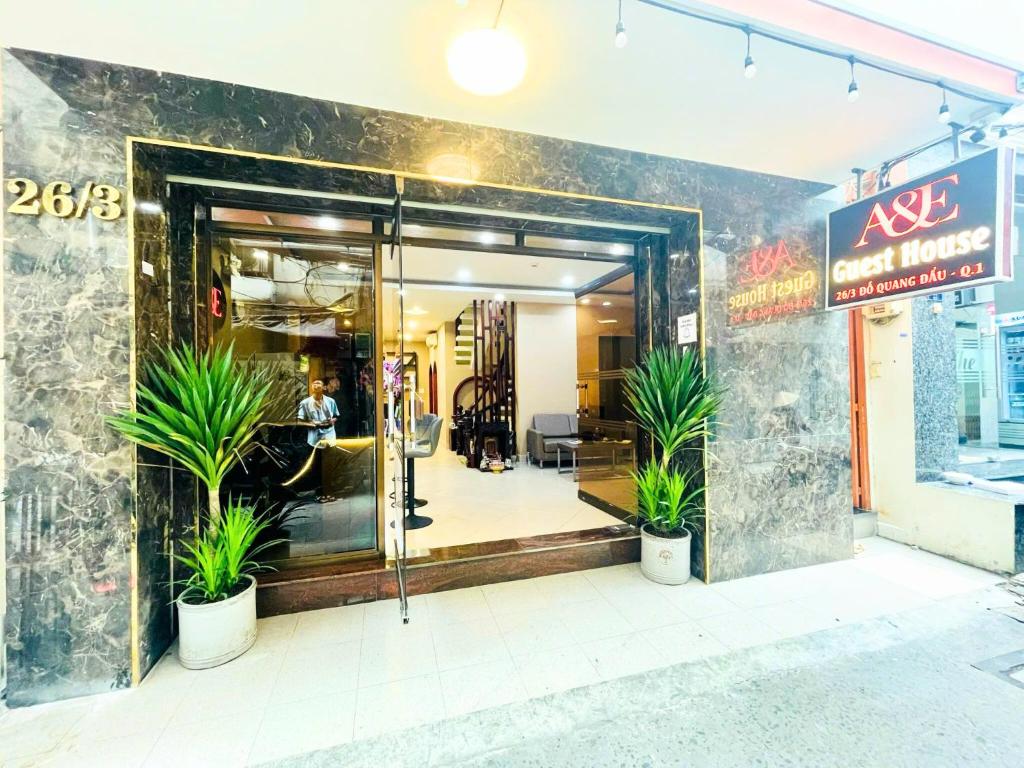 a store entrance with potted plants in front of it at A&E Guesthouse - Near Bui Vien Walking Street in Ho Chi Minh City