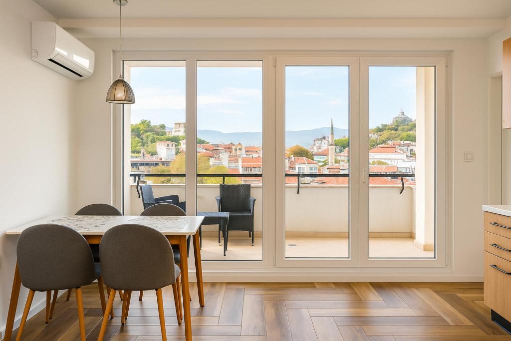 a kitchen and dining room with a table and chairs at South Panoramic Apartment in the art district of Kapana in Plovdiv