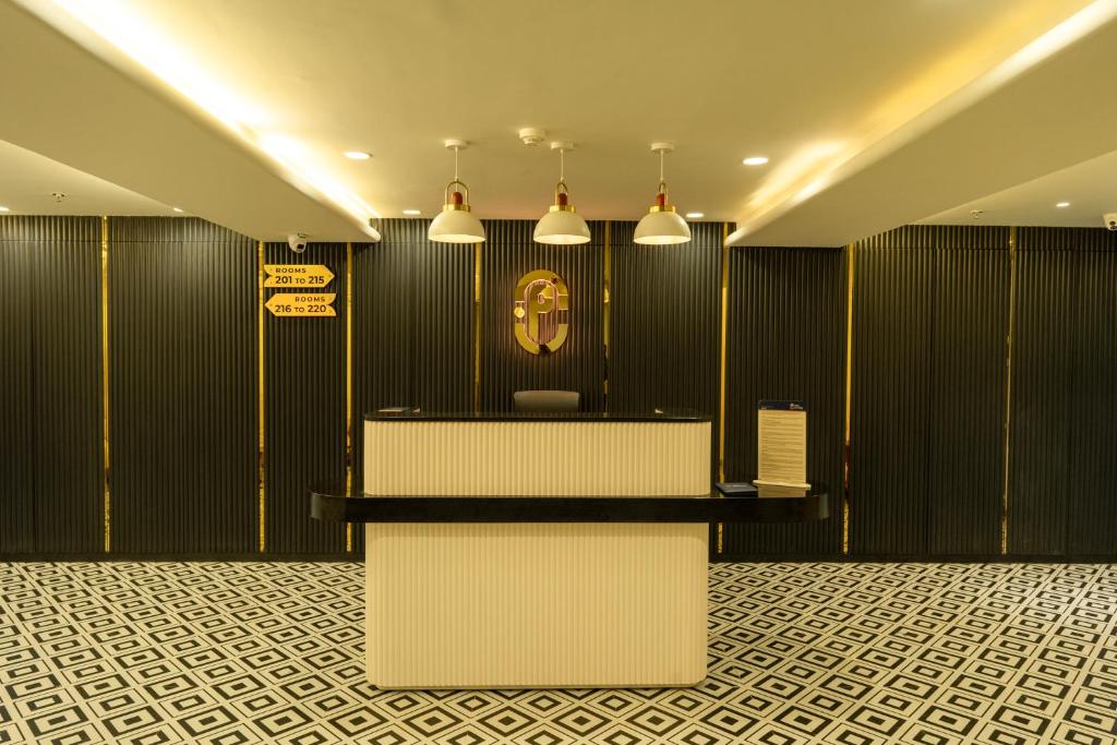a waiting room with a clock on the wall at Hotel City Pride in Mahuva
