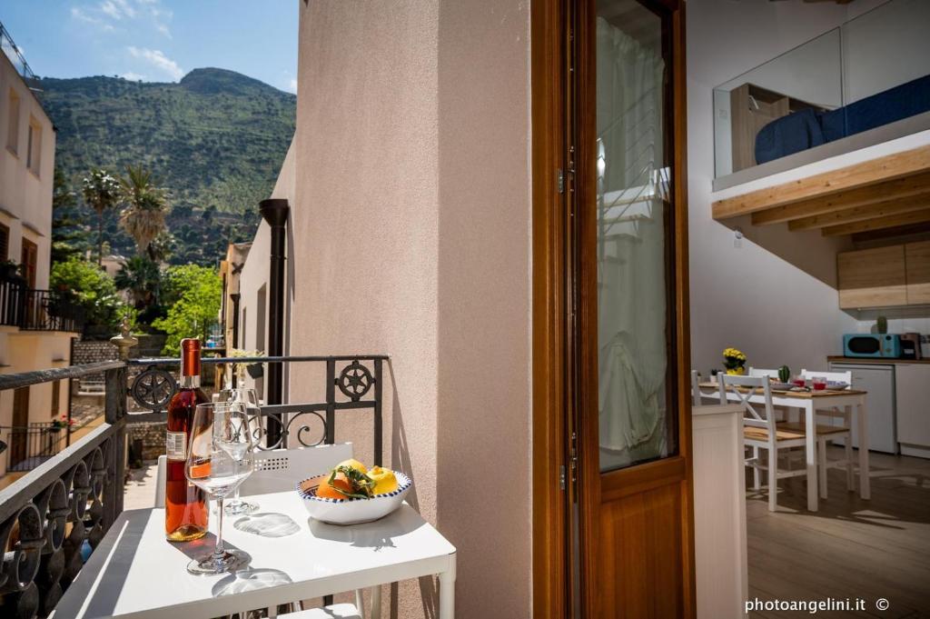 a table with a bowl of fruit on a balcony at Borgo La Chiusa in Castellammare del Golfo