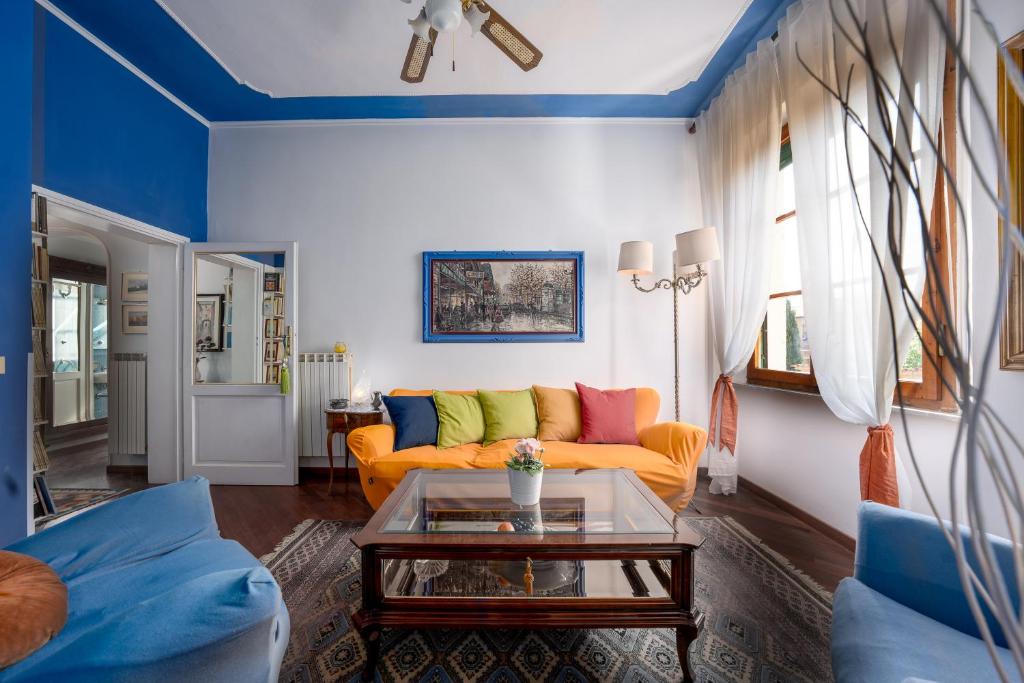 a living room with a couch and a table at Casa nel Borgo Toscano- Casole d'Elsa in Casole dʼElsa