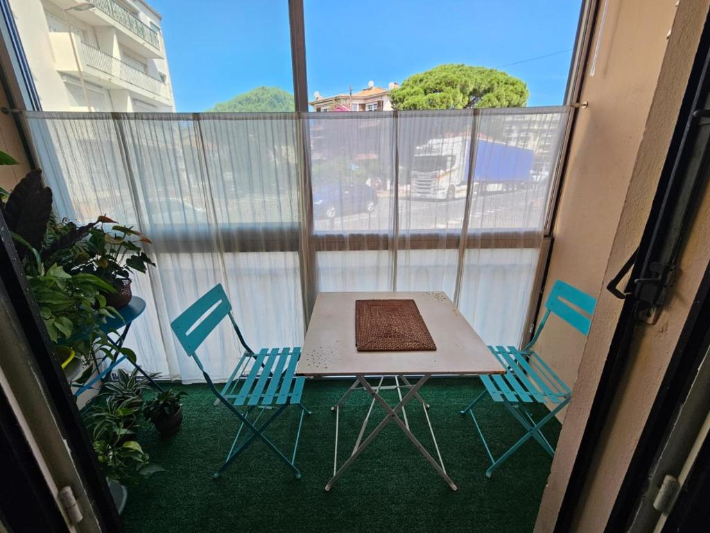 un balcon avec une table et des chaises sur un balcon dans l'établissement 3 pièces à 50 m de la plage, à Fréjus