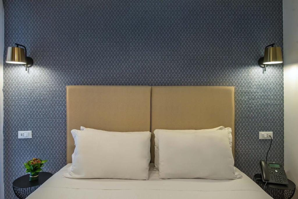 Postel nebo postele na pokoji v ubytování Essence Collection Hotel