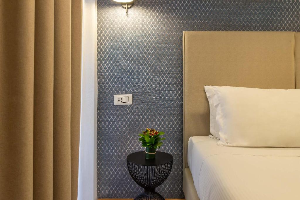 Postel nebo postele na pokoji v ubytování Essence Collection Hotel