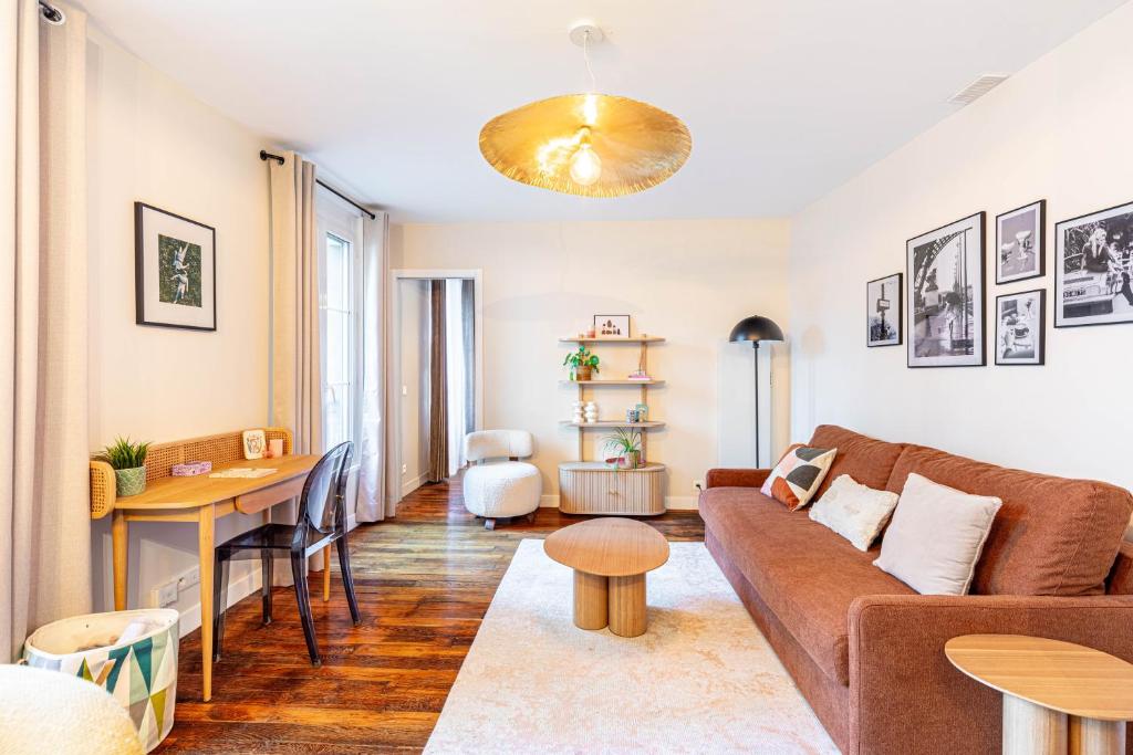 un salon avec un canapé et une table dans l'établissement Chambre au calme près du Père-Lachaise, à Paris