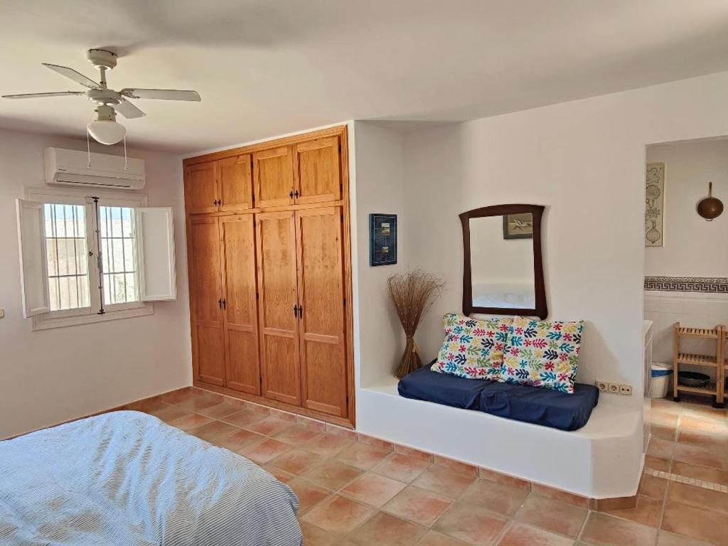 a bedroom with a bed and a mirror on the wall at Pita 4, Studio apartment in a Cortijo in Níjar
