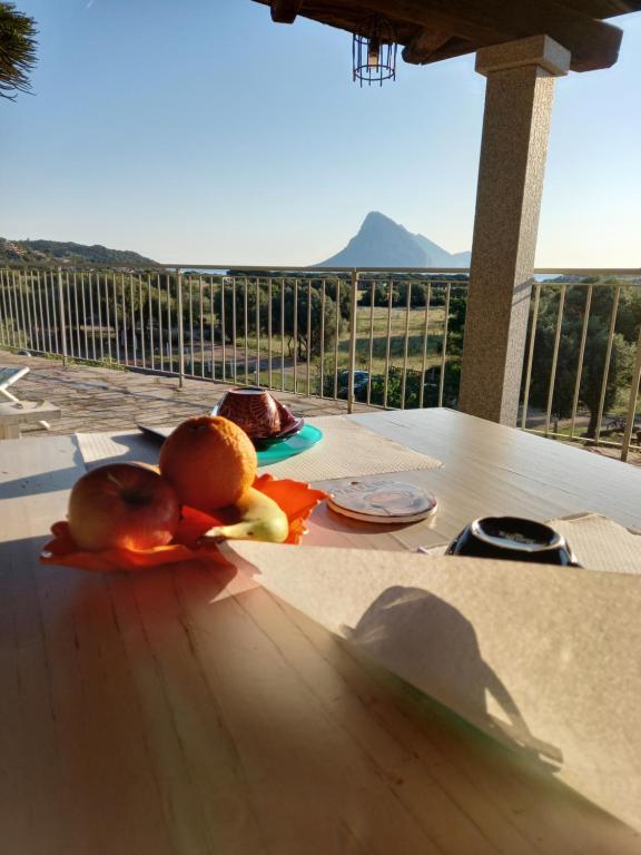 a table with some fruit on a table with a view at B&B La Taerra in Porto San Paolo