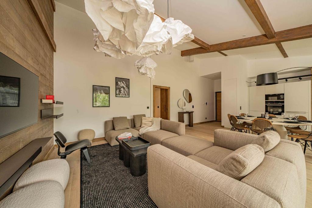 - un salon avec des canapés et une salle à manger dans l'établissement Paradisa Penthouse, à Chamonix-Mont-Blanc