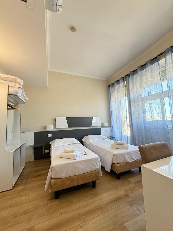Postel nebo postele na pokoji v ubytování Hotel Laura
