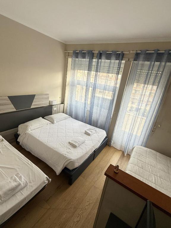 Postel nebo postele na pokoji v ubytování Hotel Laura