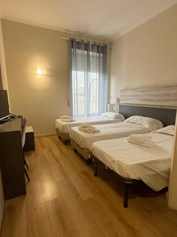 Postel nebo postele na pokoji v ubytování Hotel Laura