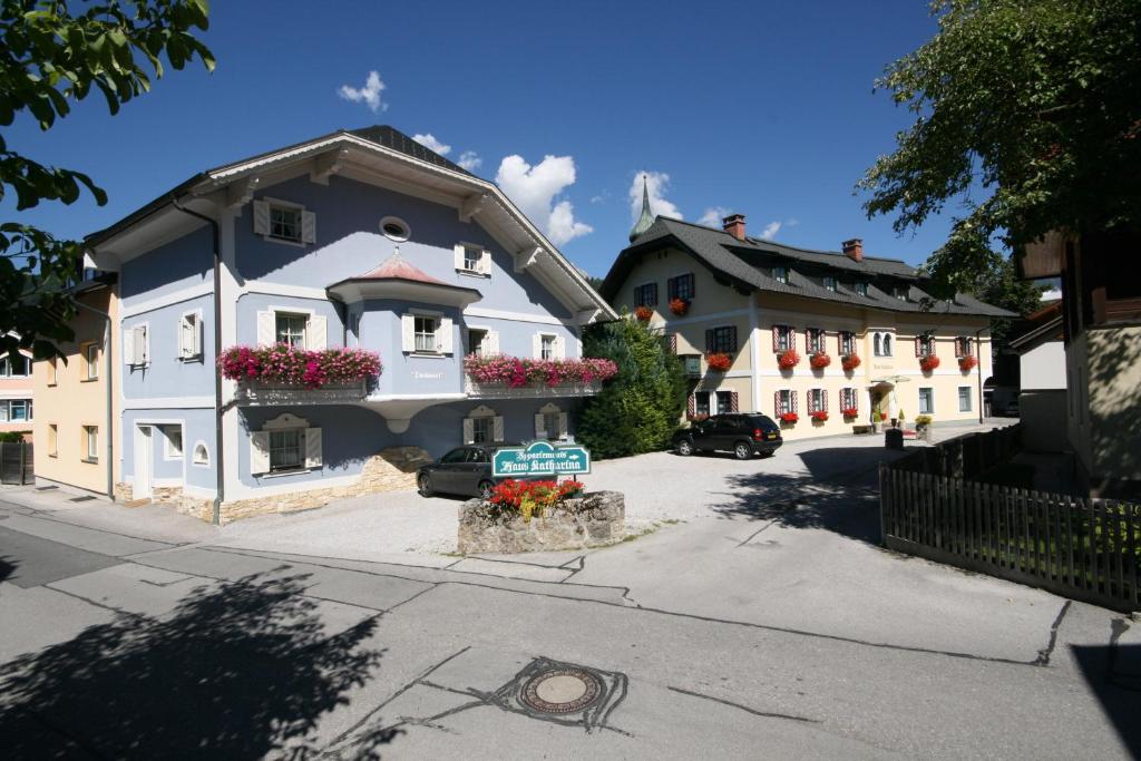 a white building with flower boxes on the side of a street at Gästehaus Katharina in Schladming