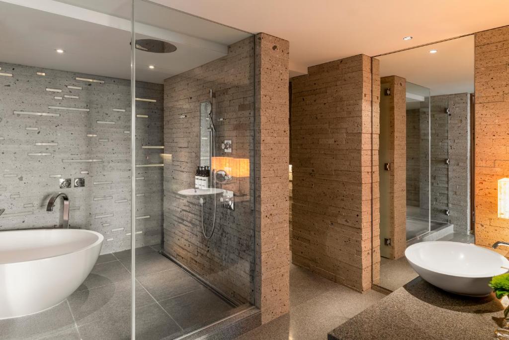 a bathroom with a tub and a shower and a sink at Hyatt Regency Tokyo in Tokyo