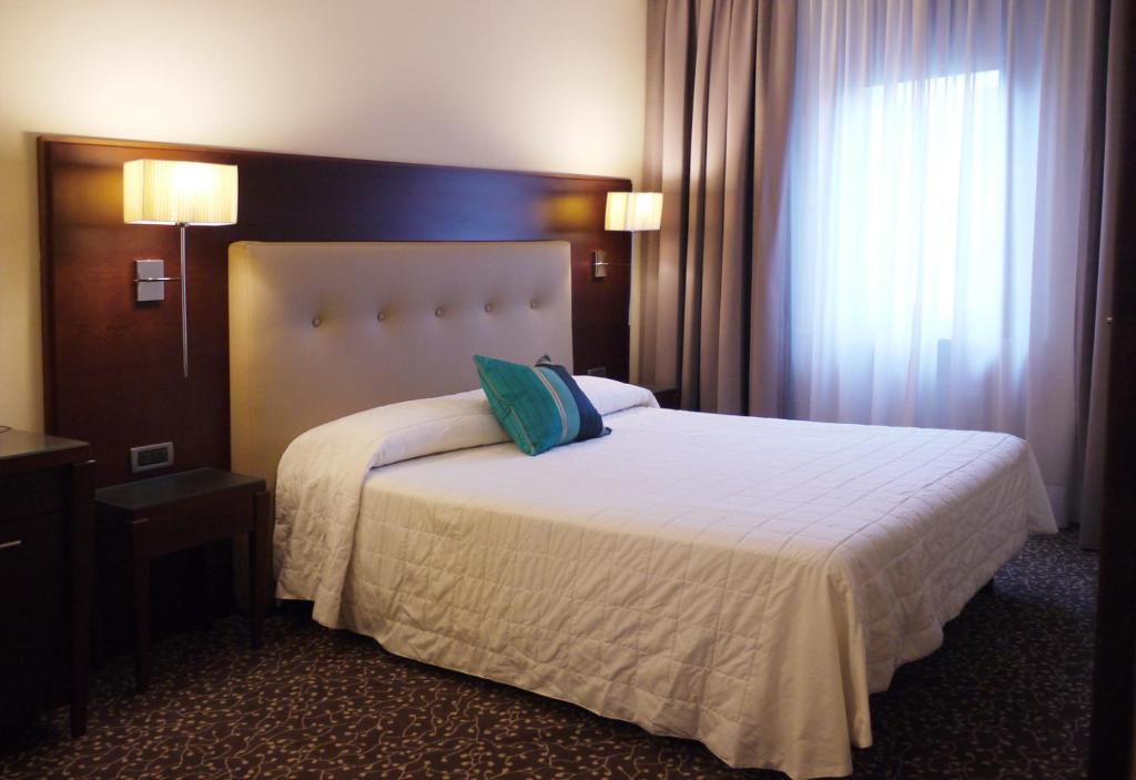 Postel nebo postele na pokoji v ubytování Hotel Castello