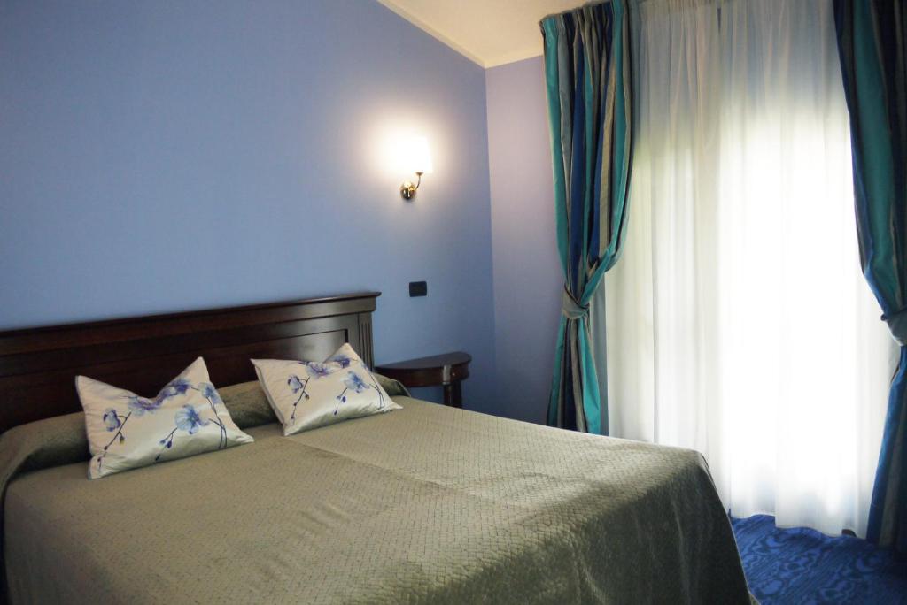 Postel nebo postele na pokoji v ubytování Hotel Castello