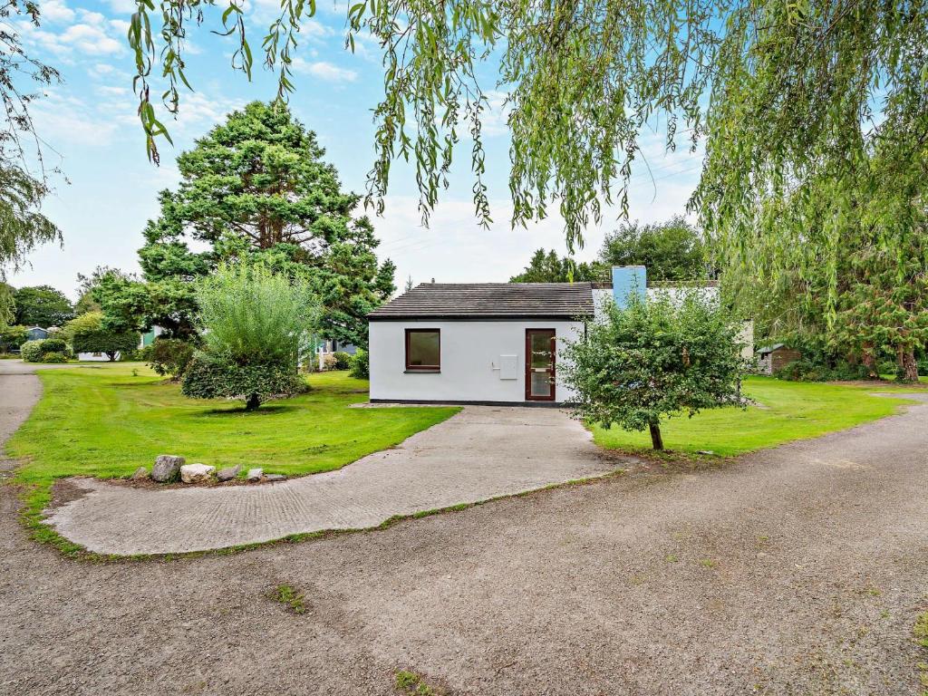 a small white house with a driveway at 3 Bed in Saltash 30040 in Landrake