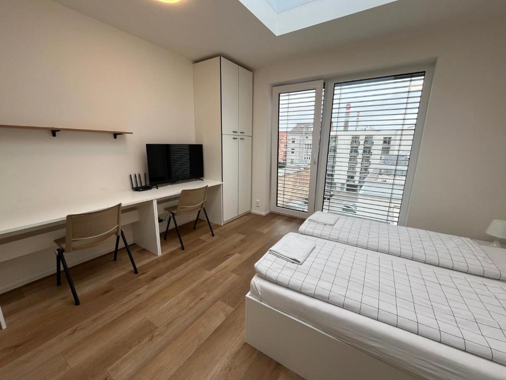 Postel nebo postele na pokoji v ubytování Bella Apartments Brno