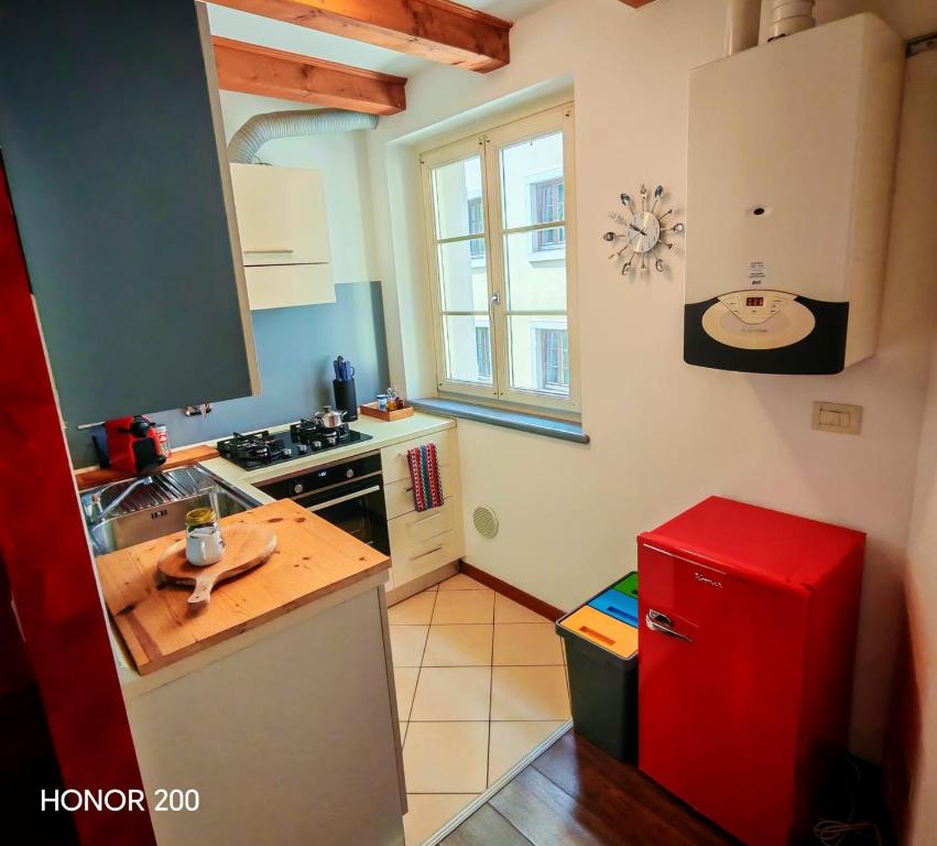 a kitchen with a red refrigerator and a sink at Home Art & Design in Trieste