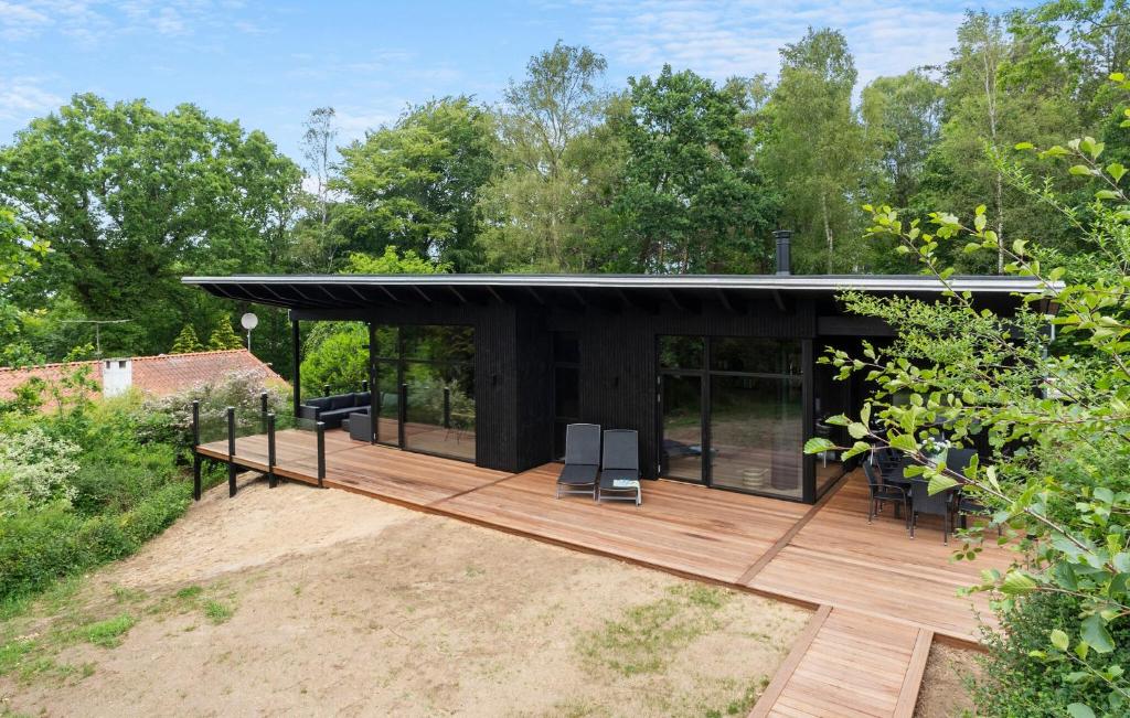 a black house with a wooden deck at Beautiful Home In Børkop With Sauna in Børkop