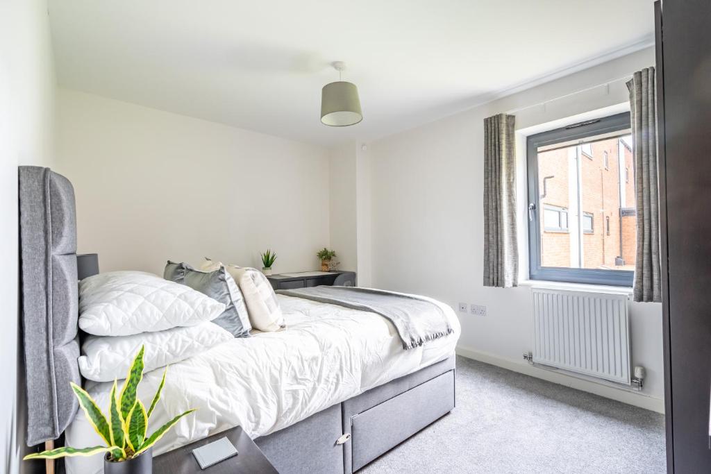 a white bedroom with a bed and a window at Garden View in York