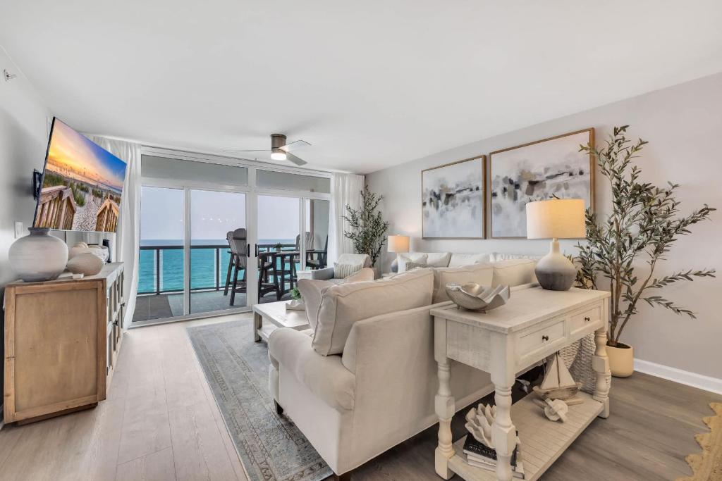 a living room with a couch and a table at All New Oceanfront Luxury w Lazy River in Myrtle Beach