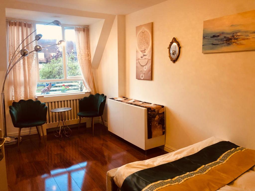 a bedroom with a bed and a window at London Central 4 bed House with Garden in London