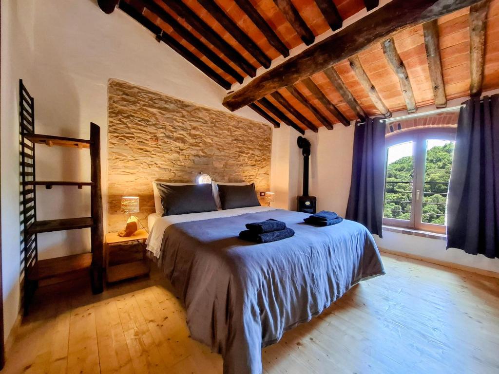 Postel nebo postele na pokoji v ubytování Il Palazzo, Le Fornaci