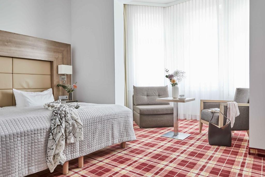 Postel nebo postele na pokoji v ubytování Hotel Binzer Hof
