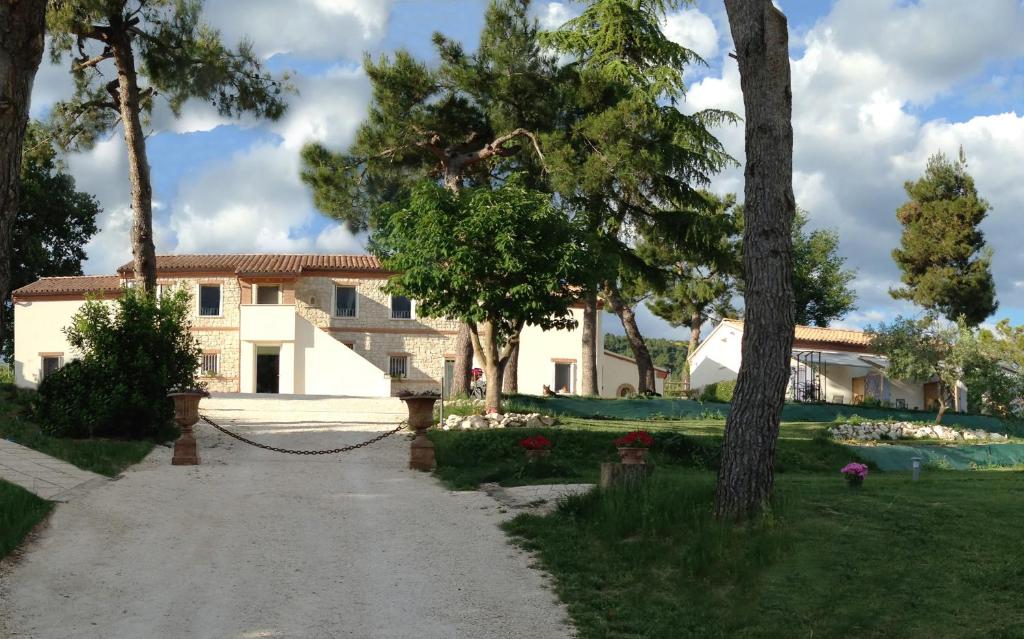 a house with a chain in front of a yard at Borgoparvo Countryvilla in Sirolo