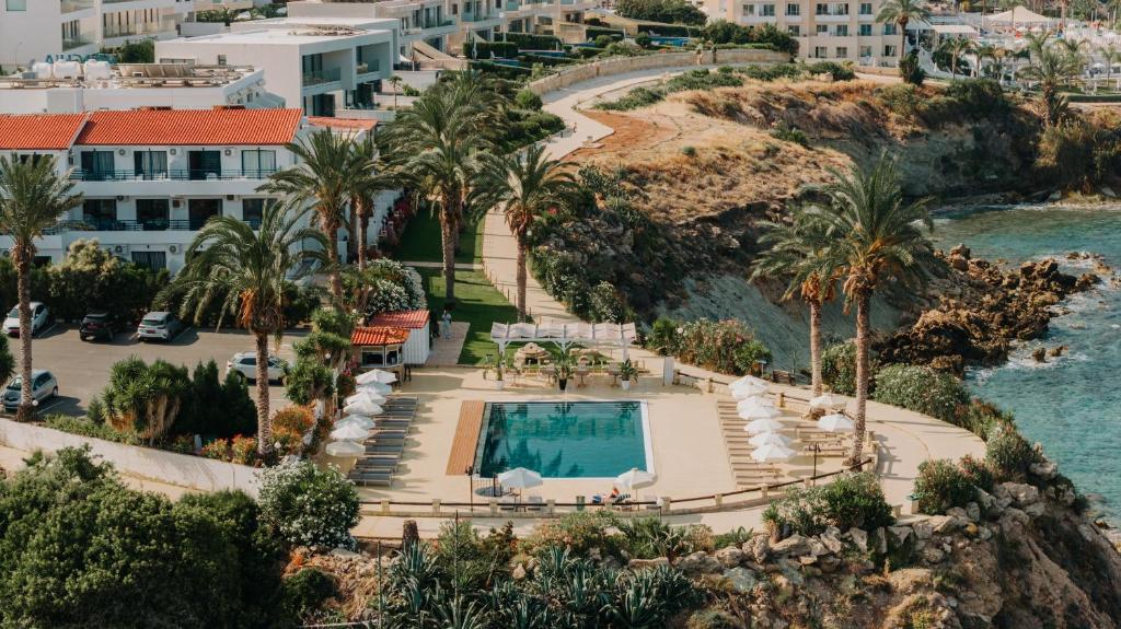 an aerial view of a resort with a swimming pool at Vrachia Beach Hotel & Suites - Adults Only in Paphos