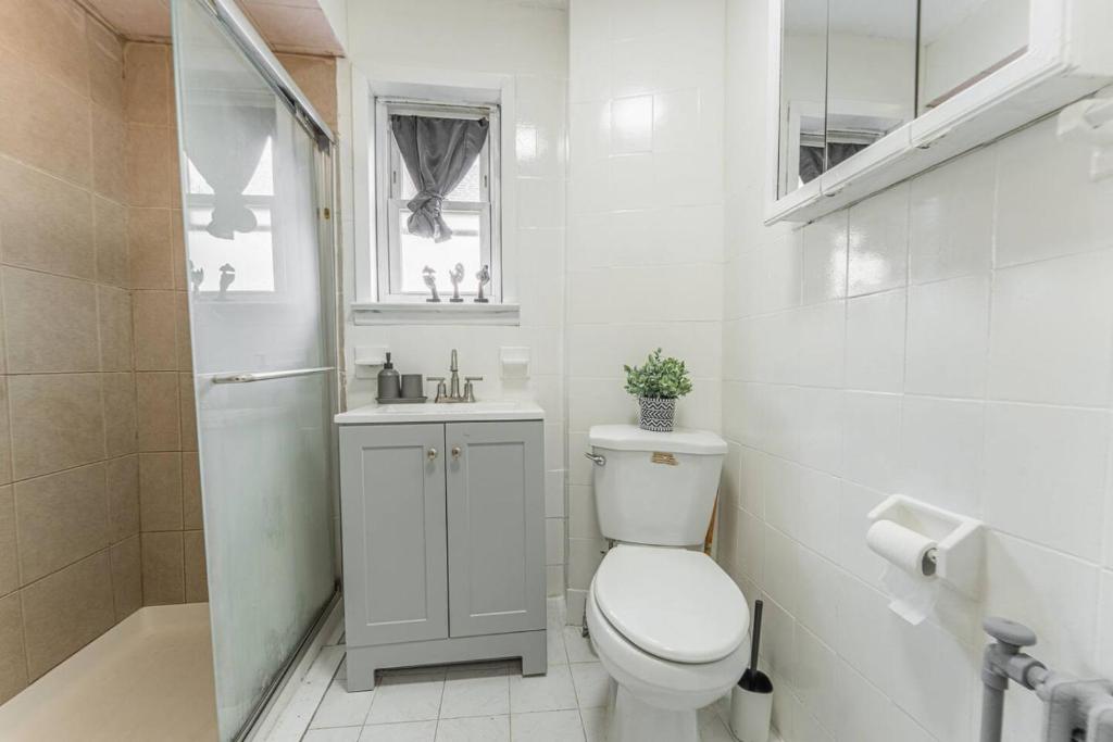 un bagno bianco con un water e un lavandino di NYC Train EWR Liberty Park 1 a Bayonne