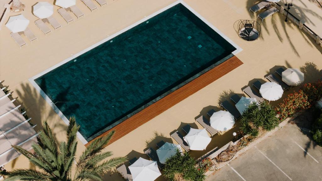 an overhead view of a swimming pool in a house at Vrachia Beach Hotel & Suites - Adults Only in Paphos