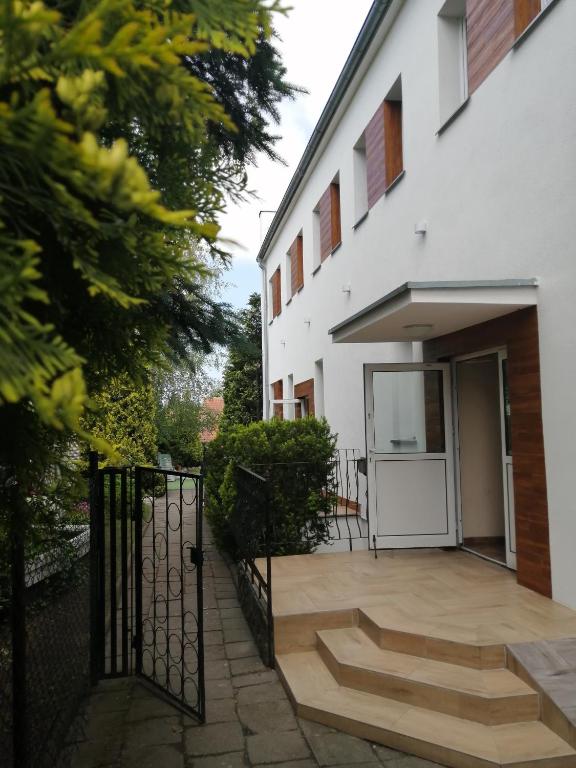 a porch of a white building with a gate at Głębia in Dąbrówno