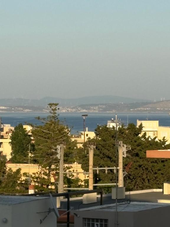 a view of a city with the ocean in the background at SMYRNA HOMES KALYOPi in Chios